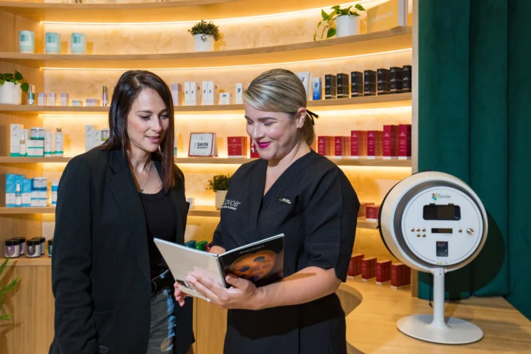 Skin consultation at Lovoir — a therapist assessing a client's skin