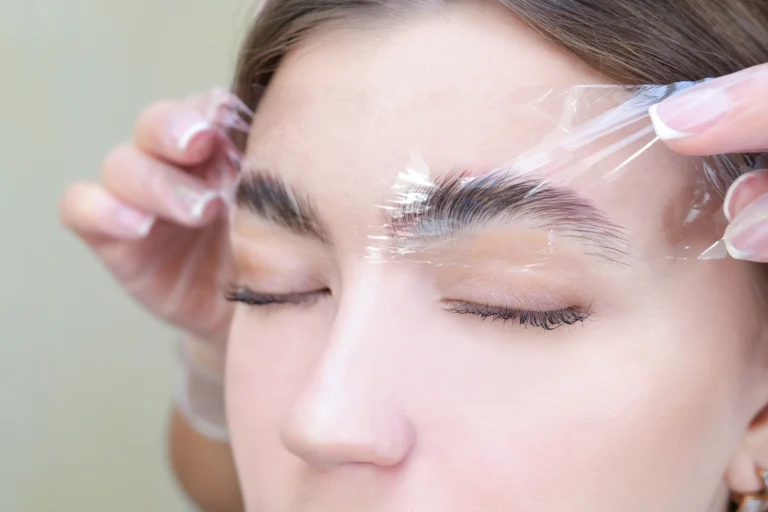 Brow Lamination — a therapist giving a client an eyebrow lamination