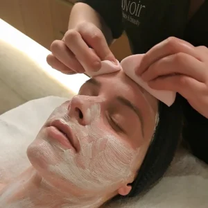 Chemical Peel at Lovoir — a therapist giving a client a chemical peel
