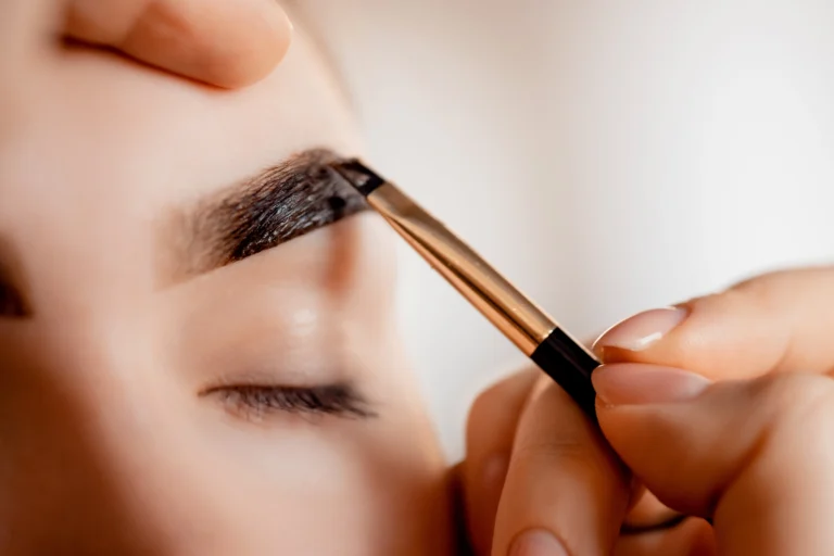 Brow Lamination — a therapist performing eyebrow tinting on a client