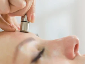 Microdermabrasion Facial — therapist performing microdermabrasion on client's face