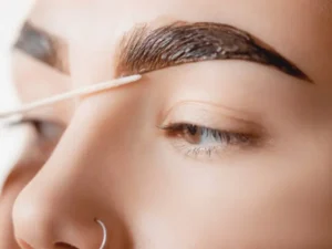 Hybrid Brows — a therapist applying hybrid brow tint on a client