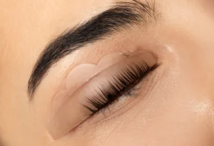 Lash Lift — a therapist giving a client a Lash Lift