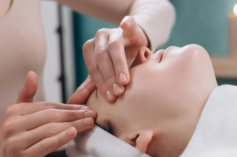 Lymphatic Facial — a therapist giving a client an Lymphatic Facial